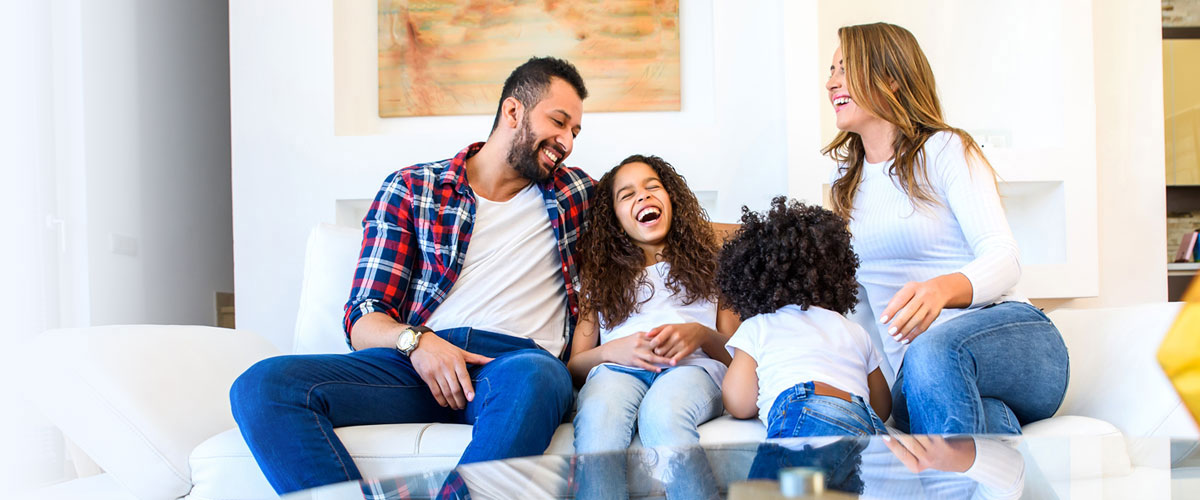Family laughing and happy in pest free living room